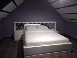 a bedroom with a white bed in a attic at Villa Peri room room in Sapanca