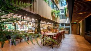 a restaurant with tables and chairs in a building at De Egmonden in Egmond aan Zee