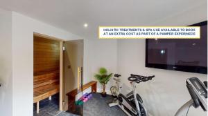 a room with two bikes and a tv on a wall at Hidden Gem Retreat in Budleigh Salterton