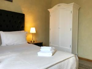a bedroom with a bed with towels on it at Guest House Le Contesse in Florence