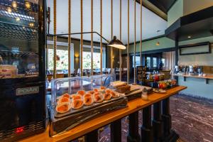 a bakery with a counter with oranges and other foods at DIEHLs Hotel in Koblenz +109 photos