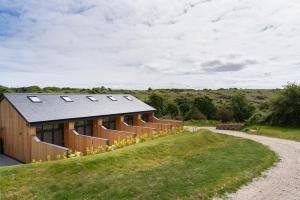 a house with a solar roof on a hillside at Romano Estate, The Courtyard in Penzance