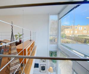 a room with a staircase and a large window at VILLA BONANOVA STYLE in Palma de Mallorca