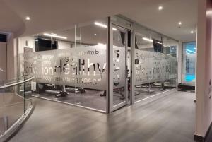 a room with glass doors with writing on it at Ramada Encore by Wyndham Guadalajara Aeropuerto in Guadalajara