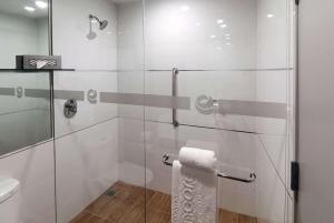 a bathroom with a glass shower with a toilet at Ramada Encore by Wyndham Guadalajara Aeropuerto in Guadalajara