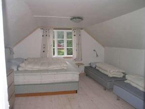a bedroom with two beds and a window at Jondal in Jondal