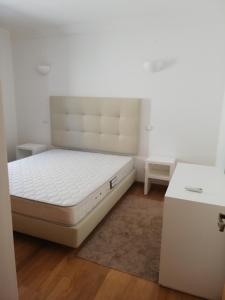 a bedroom with a white bed and a desk at Villa V2 U in Olhos de Água +34 photos