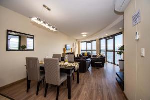 a dining room and living room with a table and chairs at Ocean View Luxury Self-Catering in Strand