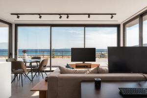 a living room with a couch and a view of the ocean at Sounio Panoramic Loft in Sounio