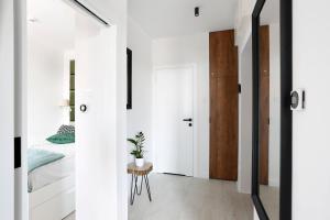 a room with white walls and a door and a bedroom at Partnerapart Rakowicka 14 Kamienica in Krakow