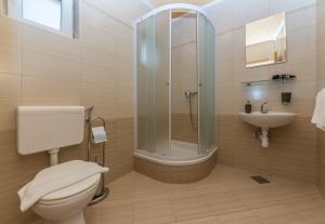 a bathroom with a shower and a toilet and a sink at Apartments Villa Vujcic in Makarska +76 photos