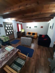 a living room with a couch and a table at Vikendica Vila Berbat in Ovčar Banja +29 photos