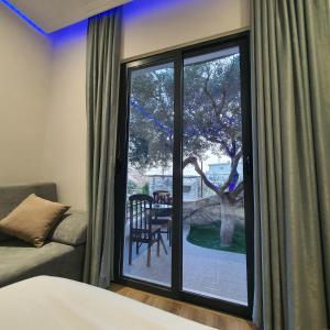a bedroom with a window with a view of a patio at Villa Mehmeti in Sarandë