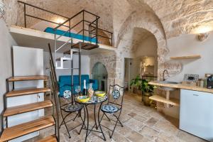 a room with a table and chairs and a loft bed at AROMA luxury in Ostuni