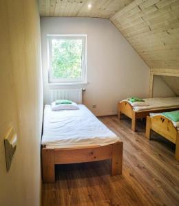 a room with two beds and a window at Pokoje nad Przełomem Dunajca - Wietrznice - Rivent Sport in Łącko