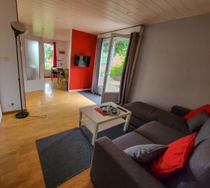 a living room with a couch and a table at Terrasses du Zimmerberg in Barr