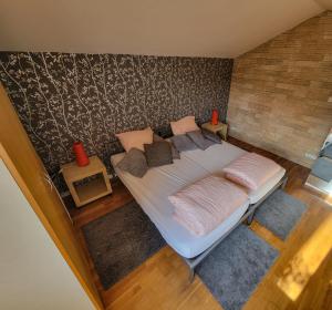 a bedroom with a large bed with two pillows on it at Terrasses du Zimmerberg in Barr