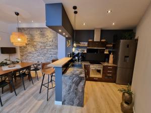 a kitchen and dining room with a stone wall at Arena Design Apartments with FREE Private Parking and with a terrace in Pula