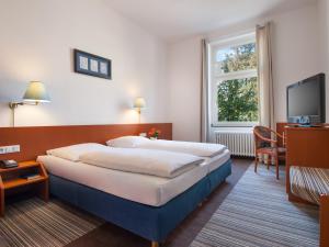 En eller flere senger på et rom på Trip Inn Hotel Schumann