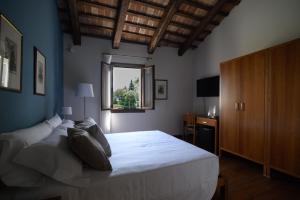 um quarto com uma grande cama branca e uma janela em Le Camere di Villa Cà Zenobio em Treviso