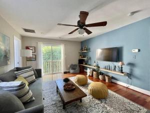 a living room with a couch and a ceiling fan at Brand New, Cozy, Modern, One-bedroom Apartment in Falls Church