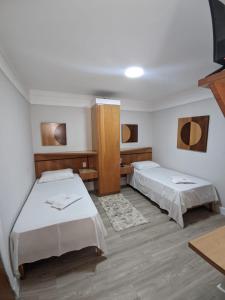 Katil atau katil-katil dalam bilik di Horto Executivo Hotel