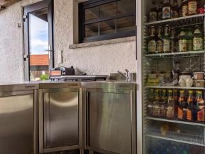 a kitchen with a refrigerator with drinks in it at Schlafstaelle in Geusfeld