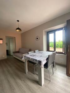 a living room with a table and chairs and a couch at Casa Vacanze Spolina Cossato BI in Cossato