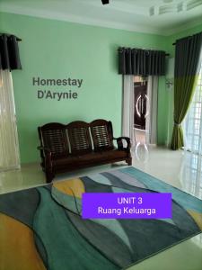 a bedroom with a bed and a couch in a room at Homestay D ARYNIE in Bukit Payong
