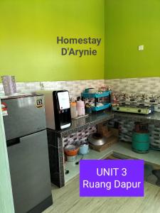 a kitchen with a counter with aperature at Homestay D ARYNIE in Bukit Payong