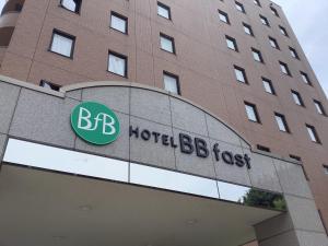 a hotel building with a sign on the front of it at HOTEL BB fast Yonezawa in Yonezawa