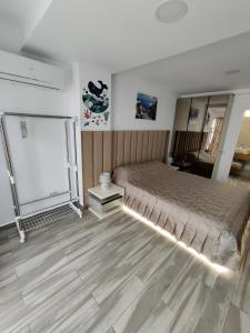 a bedroom with a bed and a table in it at Euphoria Olimp in Olimp +34 photos