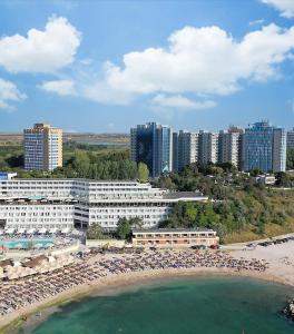 a beach with a bunch of umbrellas and buildings at Euphoria Olimp in Olimp
