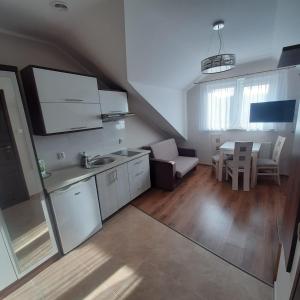 a kitchen with a sink and a table in a room at Magnat in Rowy