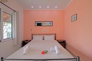 a bedroom with a bed with two towels on it at Andromaches sea view studio in Achílleion