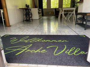 a hallway with a welcome rug on the floor at Villa Arche 1 in Neuenkirchen-Vörden