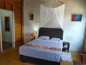 a bedroom with a bed with a canopy at Mancora Beach House in Máncora