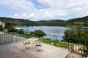 a balcony with a view of a body of water at Guest House Busurelo in Polače