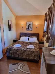 a bedroom with a bed with two towels on it at Villa Perla with Sea View in Bar
