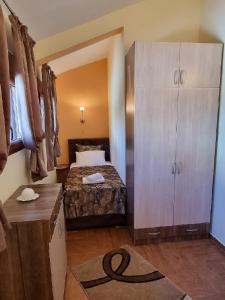 a small room with a bed and a cabinet at Villa Perla with Sea View in Bar