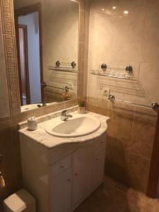 a bathroom with a sink and a mirror at Stunning Apartment - Playamarina 2 Cabo Roig in Orihuela Costa