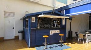 a blue bar with stools in front of it at Stunning Apartment - Playamarina 2 Cabo Roig in Orihuela Costa