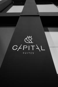 a sign with the logo of capital suites at Capital Luxury Suites in Nafplio