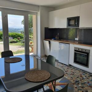 a kitchen with a table and chairs and a counter top at Figuets 3 in Châteauneuf-de-Galaure