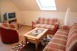 a living room with two couches and a tv at Ferienwohnung Anna in Wermelskirchen