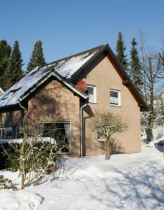 a house with snow in front of it at Ferienwohnung Anna in Wermelskirchen +7 photos