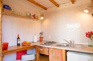 a kitchen with a sink and a counter top at Romantic Beach Cabin - Playa El Palmar in El Palmar