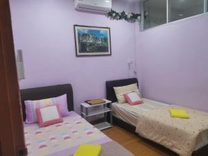 a room with two beds in a room at Jazepuri - Jaze 2 in Kuching