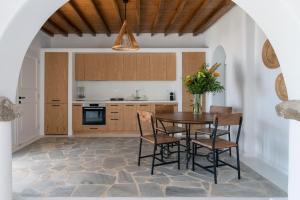a kitchen with a table and chairs in a room at Nefes Residence 2 bedroom villa in Agios Ioannis Mykonos