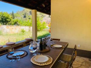 a wooden table with plates and wine glasses on it at Casa Mediteran in Stomorska